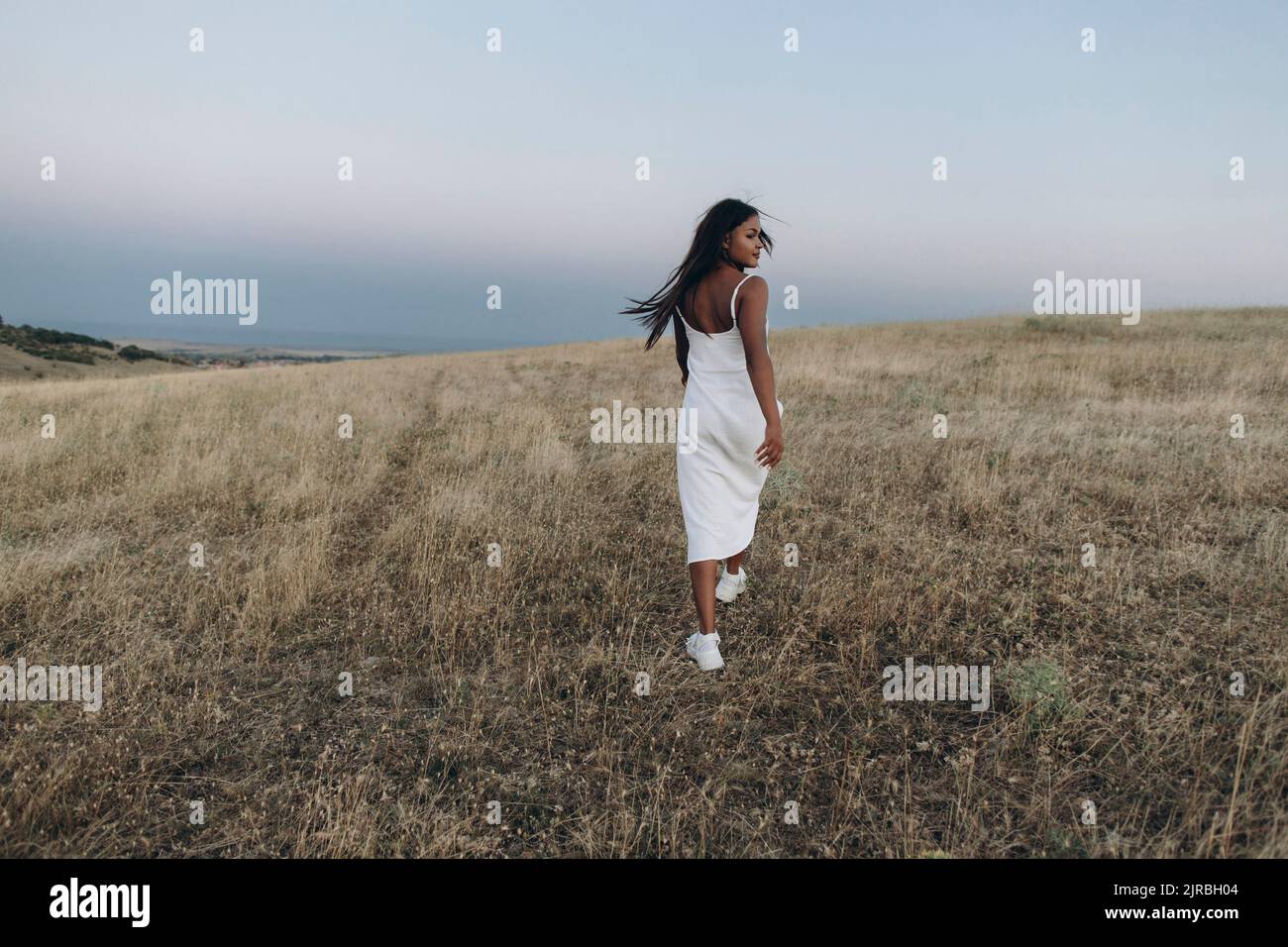 Woman walking away rear dress hi-res stock photography and images - Alamy