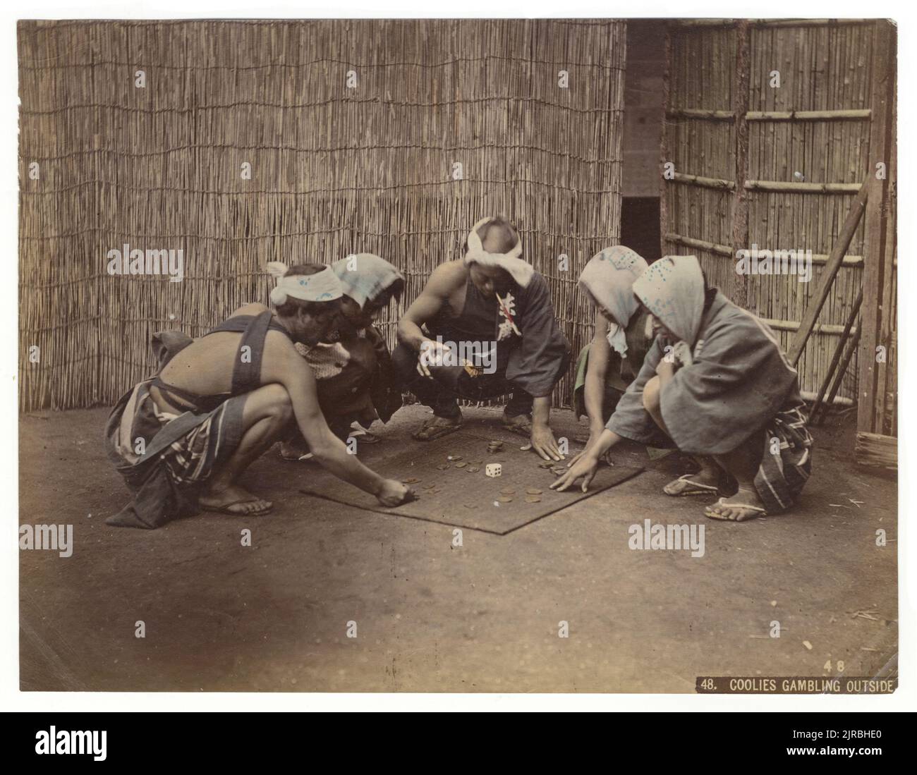 Coolies Gambling Outside, Japan, circa 1890. Photography by Kusakabe Kimbei (1841 - 1934). Stock Photo