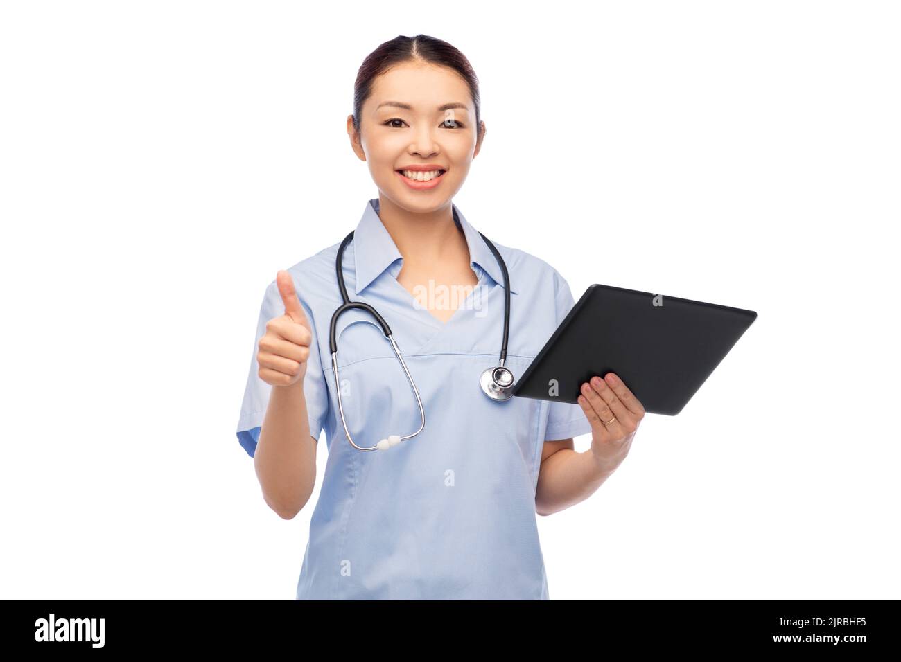 asian female nurse with tablet pc shows thumbs up Stock Photo - Alamy