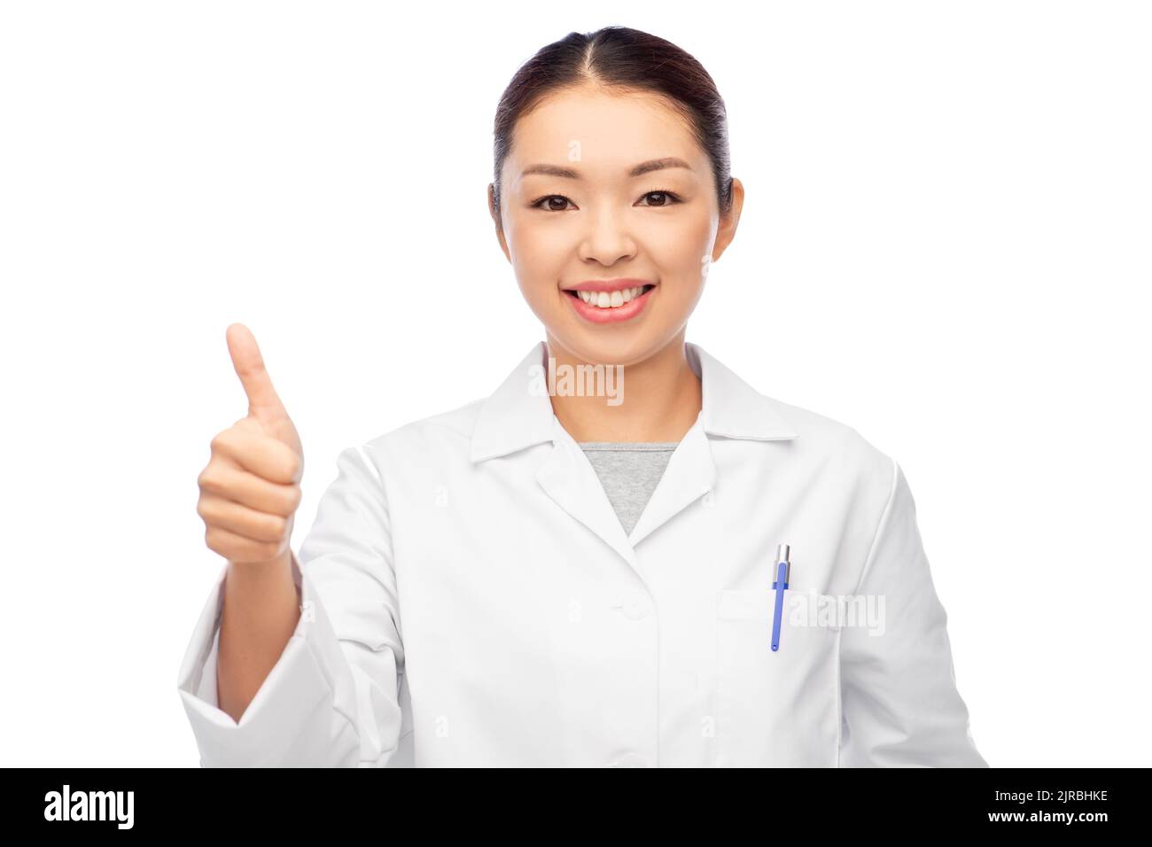 smiling asian female doctor showing thumbs up Stock Photo