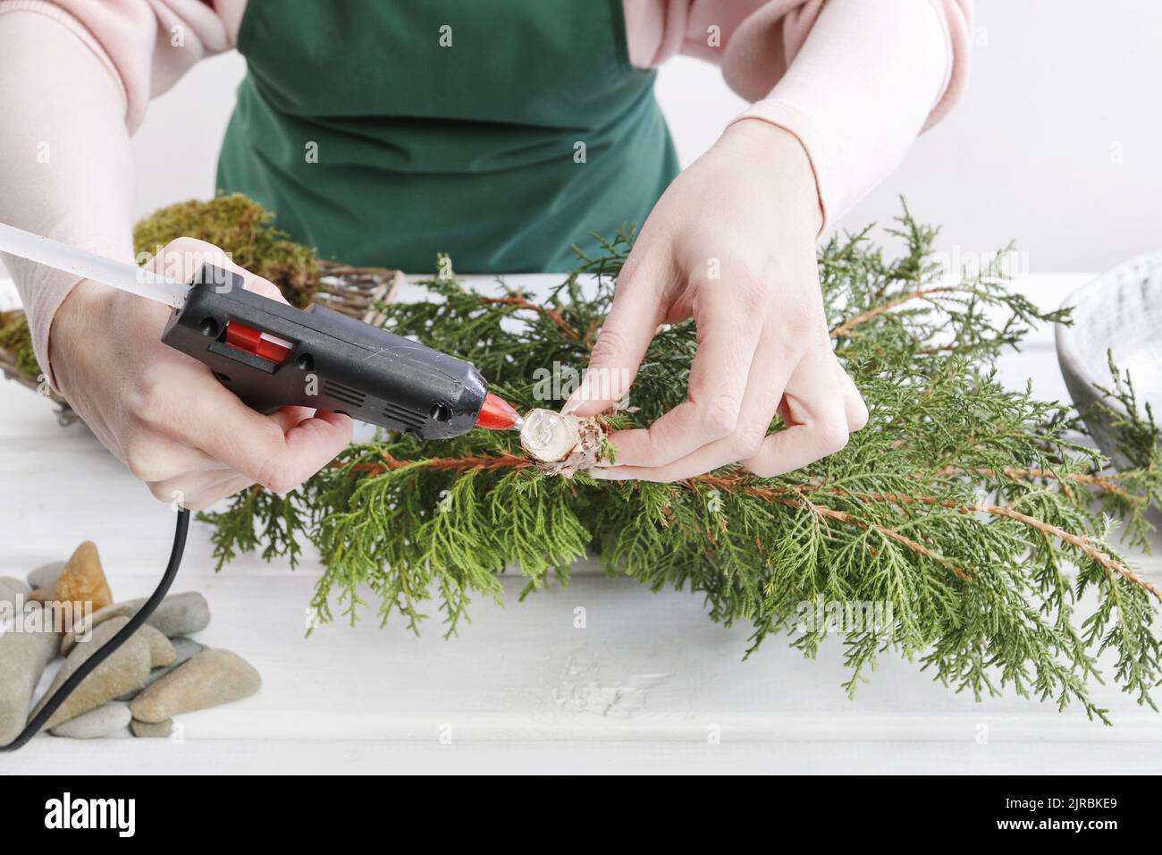Shrub Make Florist at work: Woman shows how to make small christmas tree with a ...