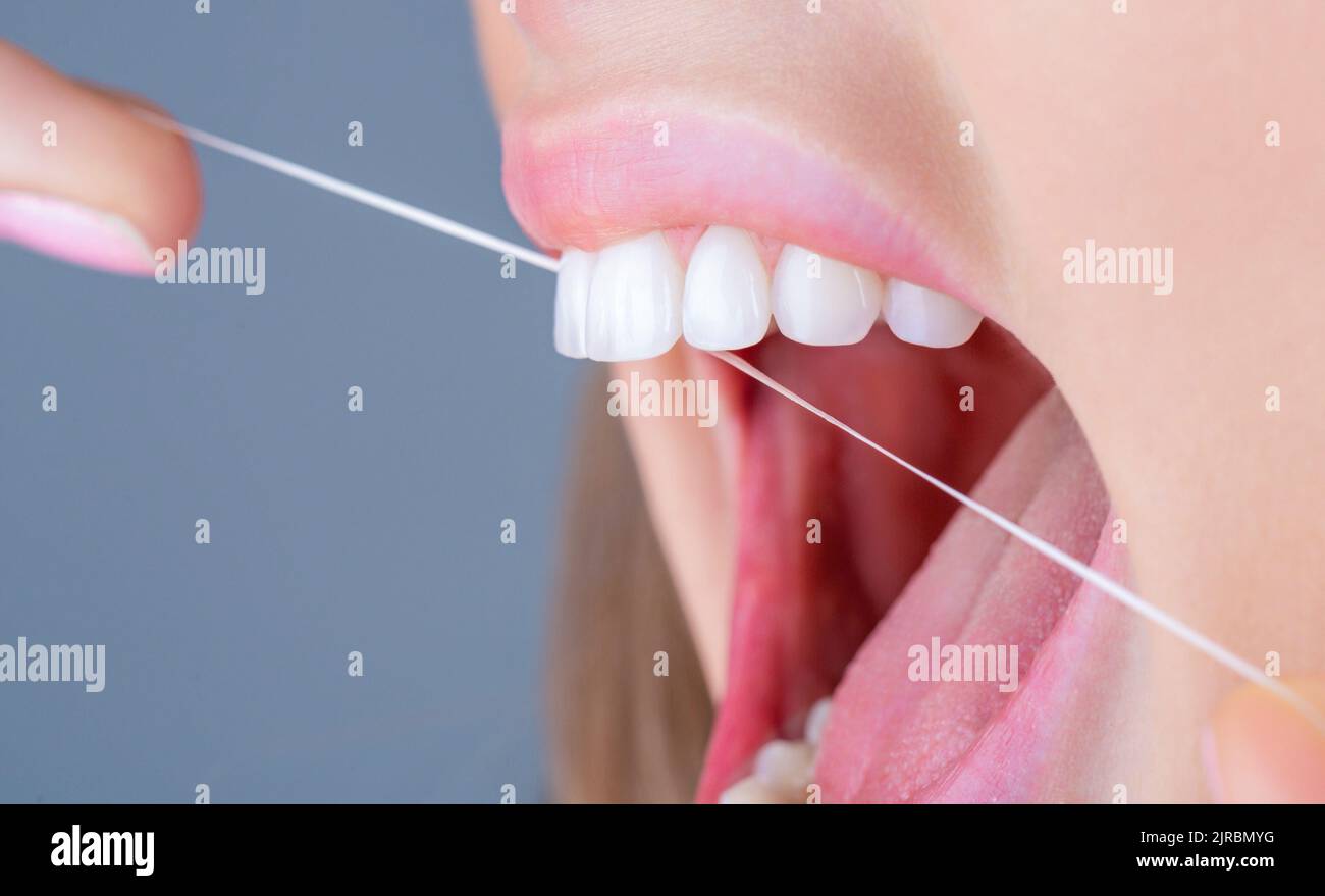 Teeths Flossing. Oral hygiene and health care. Smiling women use dental