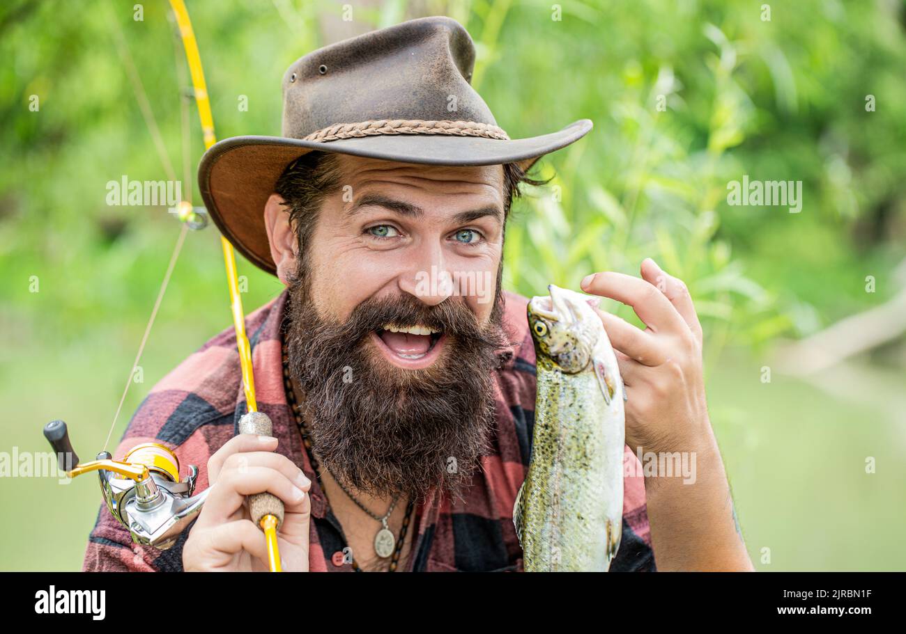 Fishing. Angler with fishing trophy. Fisherman and trout. Fishing