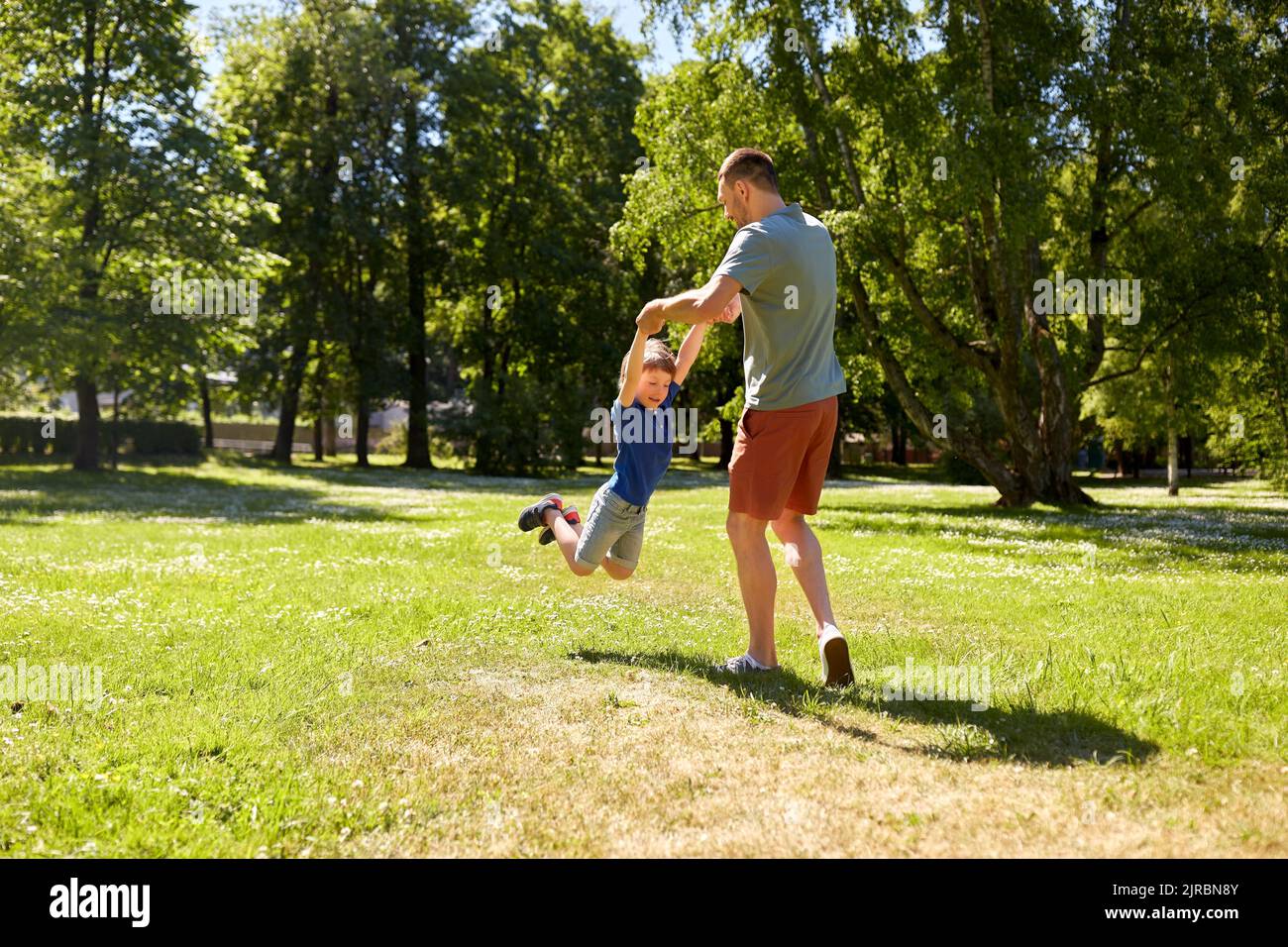happy father with son playing in summer park Stock Photo - Alamy