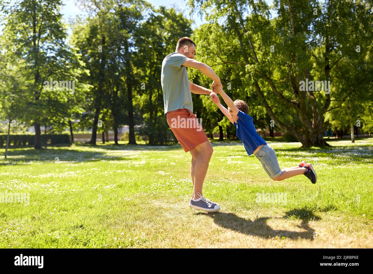 happy father with son playing in summer park Stock Photo - Alamy