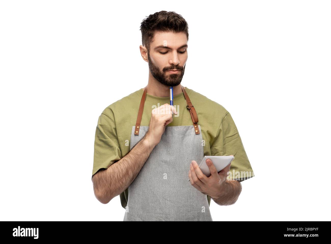 waiter in apron taking notes to notepad Stock Photo