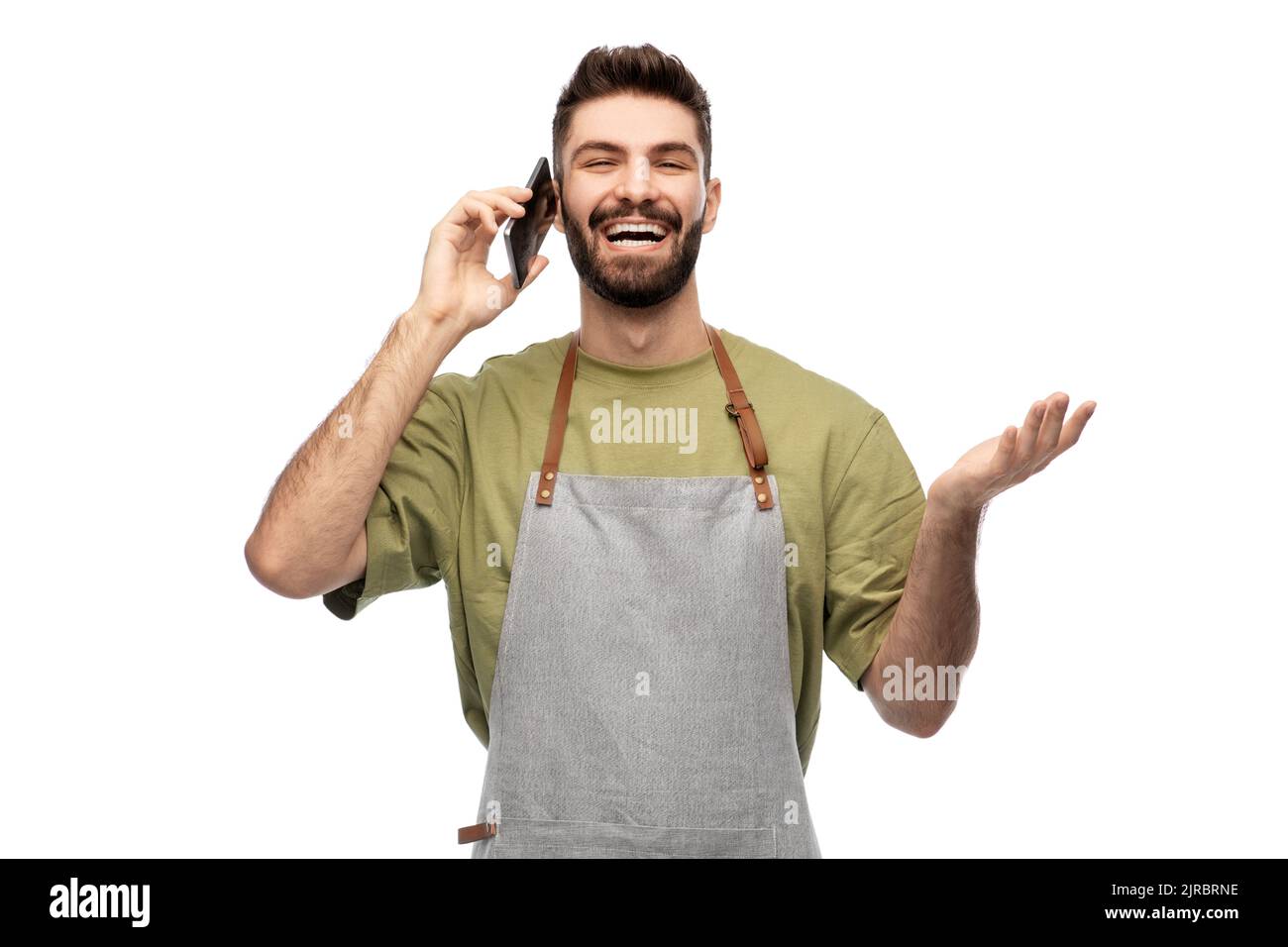happy barman in apron calling on smartphone Stock Photo