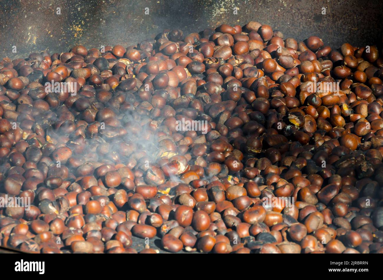 roasted chestnuts cooked on the grill in autumn Stock Photo