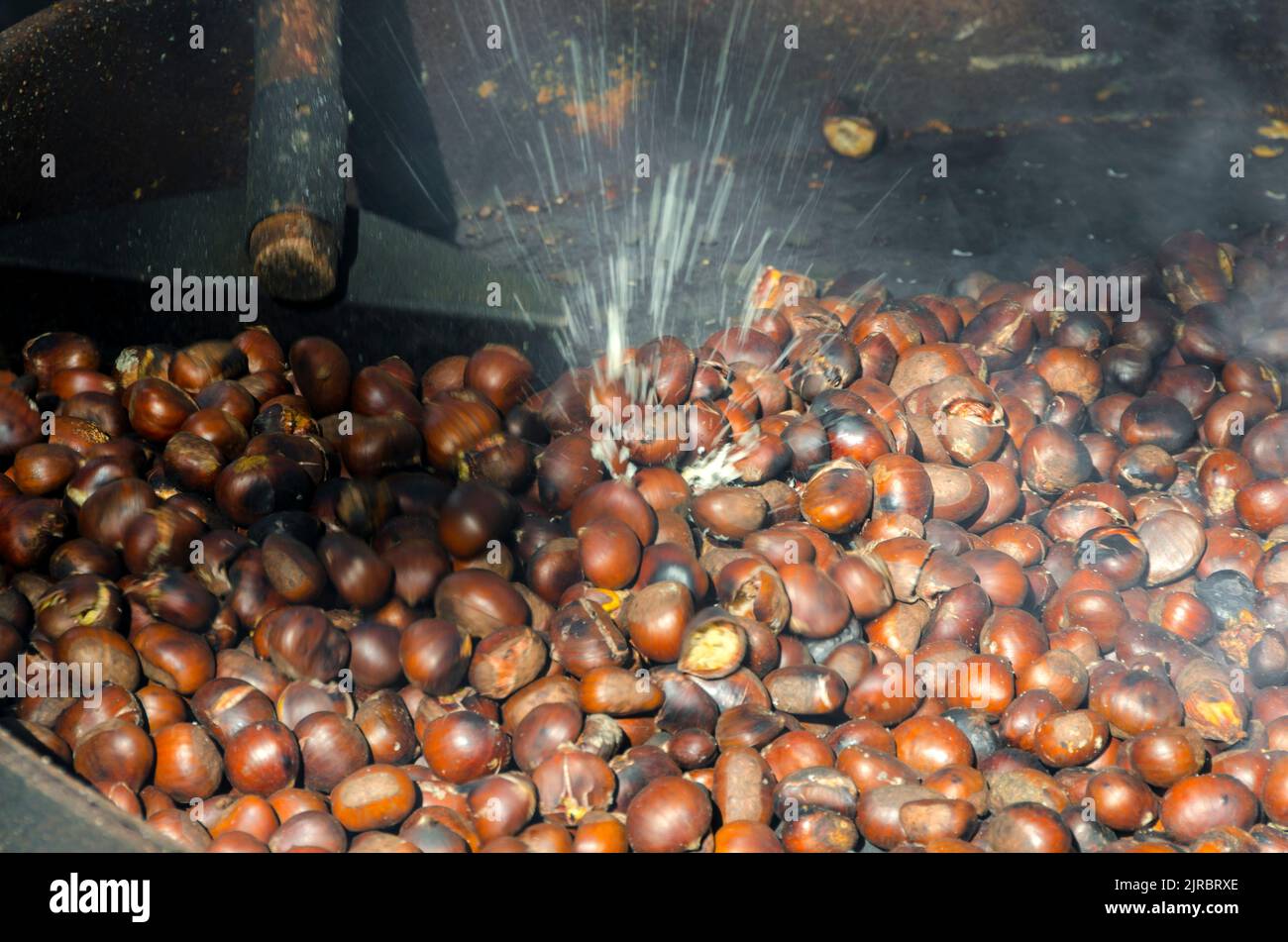 roasted chestnuts cooked on the grill in autumn Stock Photo