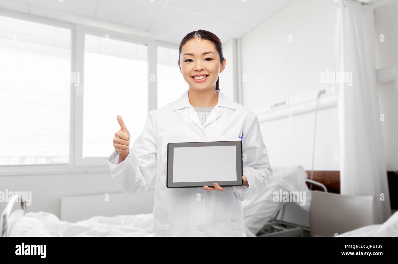 asian female doctor with tablet pc shows thumbs up Stock Photo - Alamy