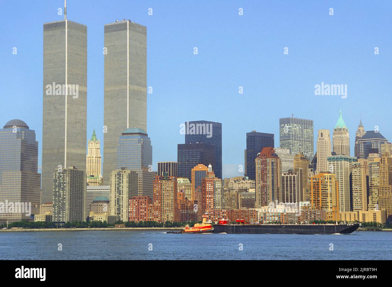 Twin Towers, World Trade Center before 9/11. View of Lower Manhattan skyscrapers in the Financial District and the Hudson River. Tugboat and scow Stock Photo