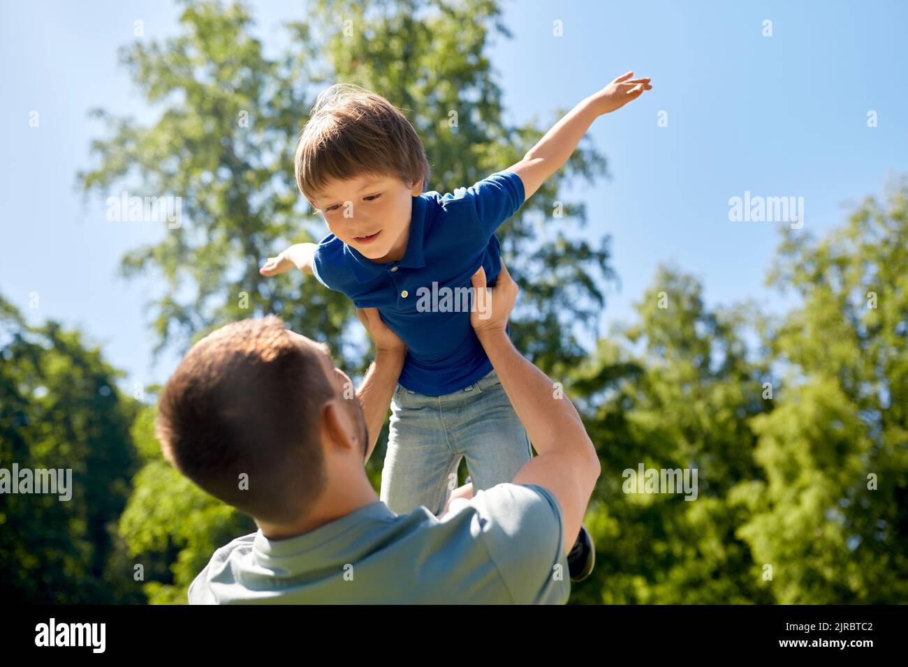 happy father with son playing in summer park Stock Photo - Alamy