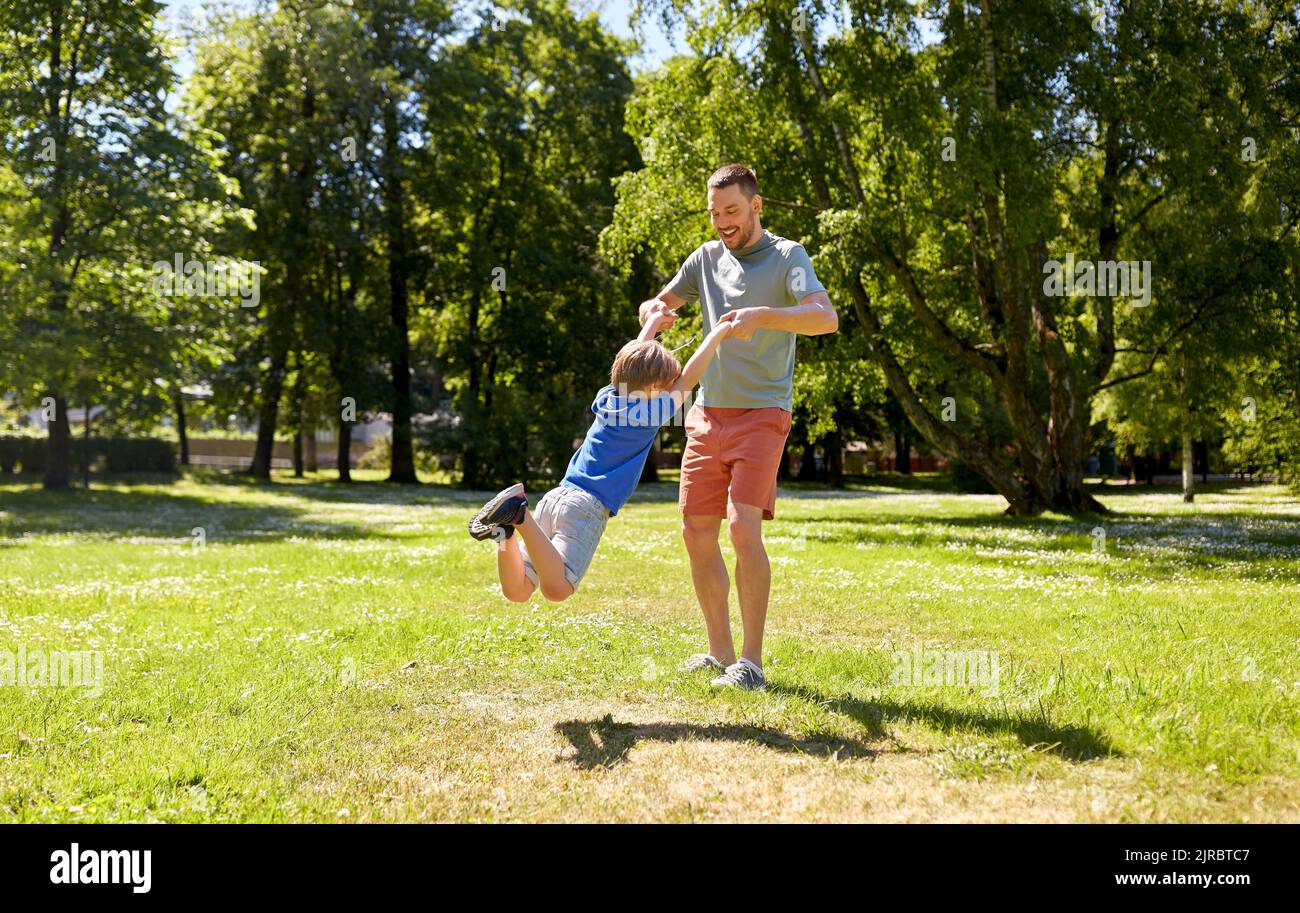 happy father with son playing in summer park Stock Photo - Alamy