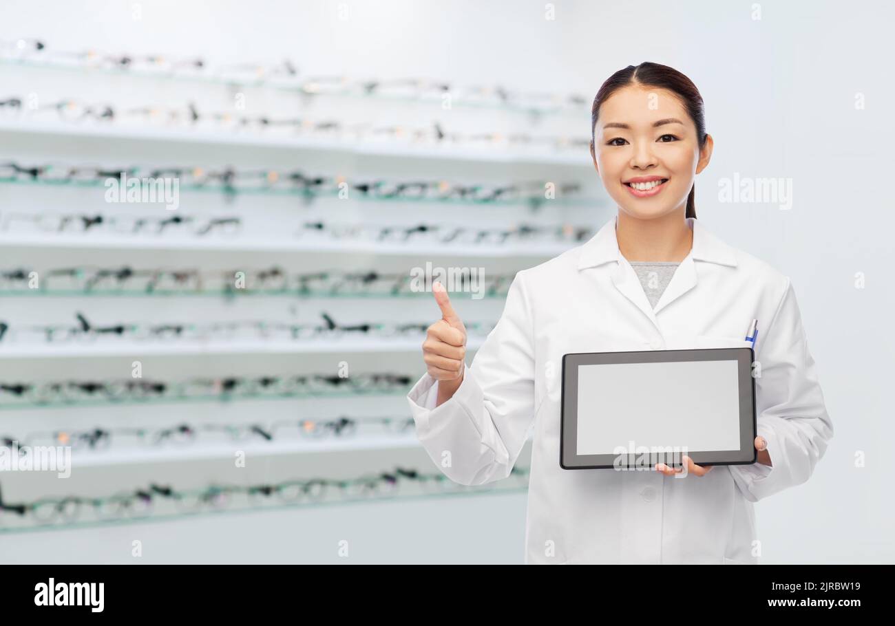 asian female doctor with tablet pc shows thumbs up Stock Photo - Alamy