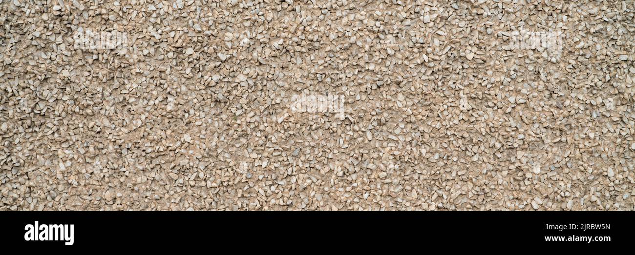 urban texture and background - building facade finished with fine gravel, wide web banner Stock Photo