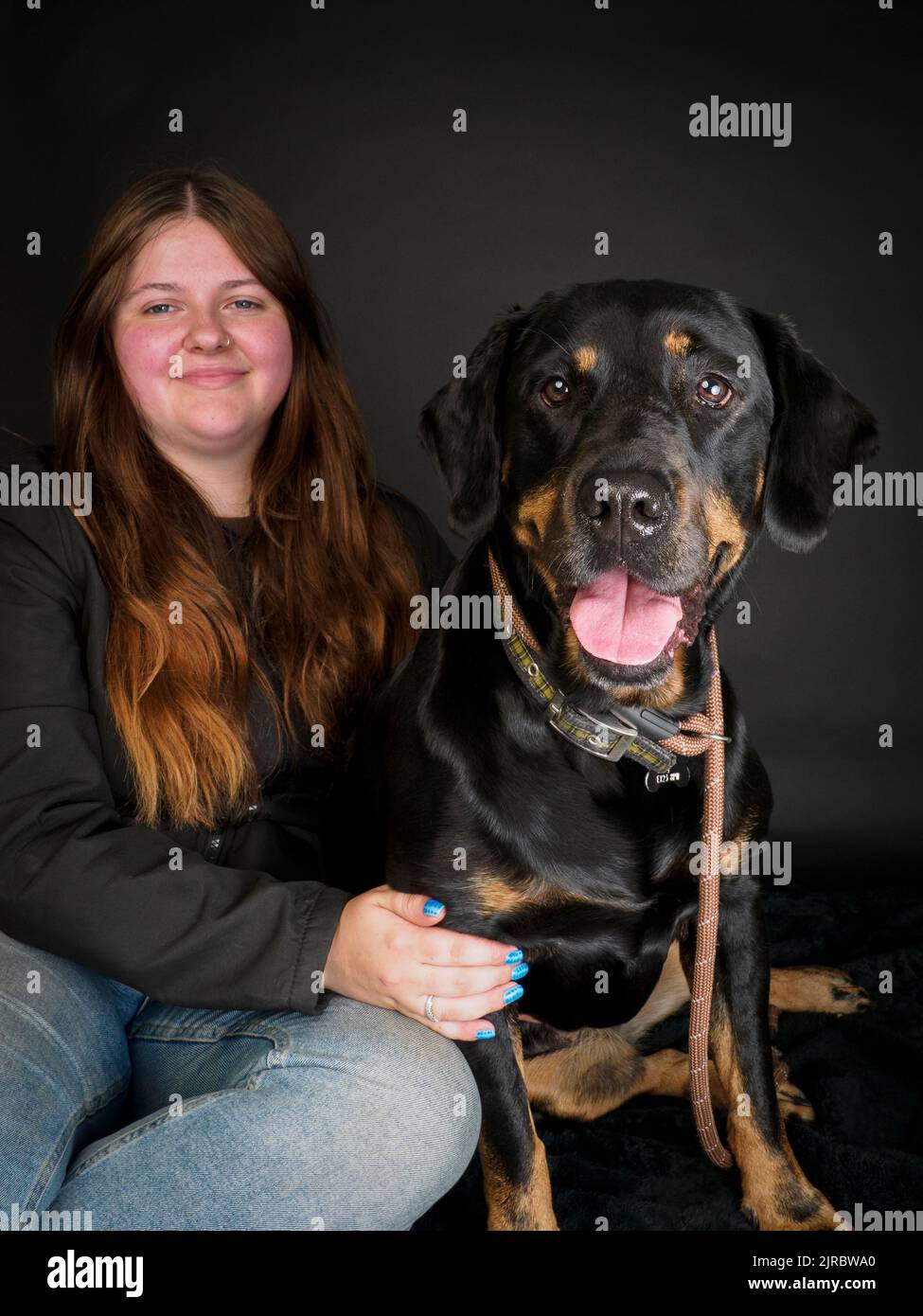 Studio portrait of a Rottweiler and owner. Stock Photo