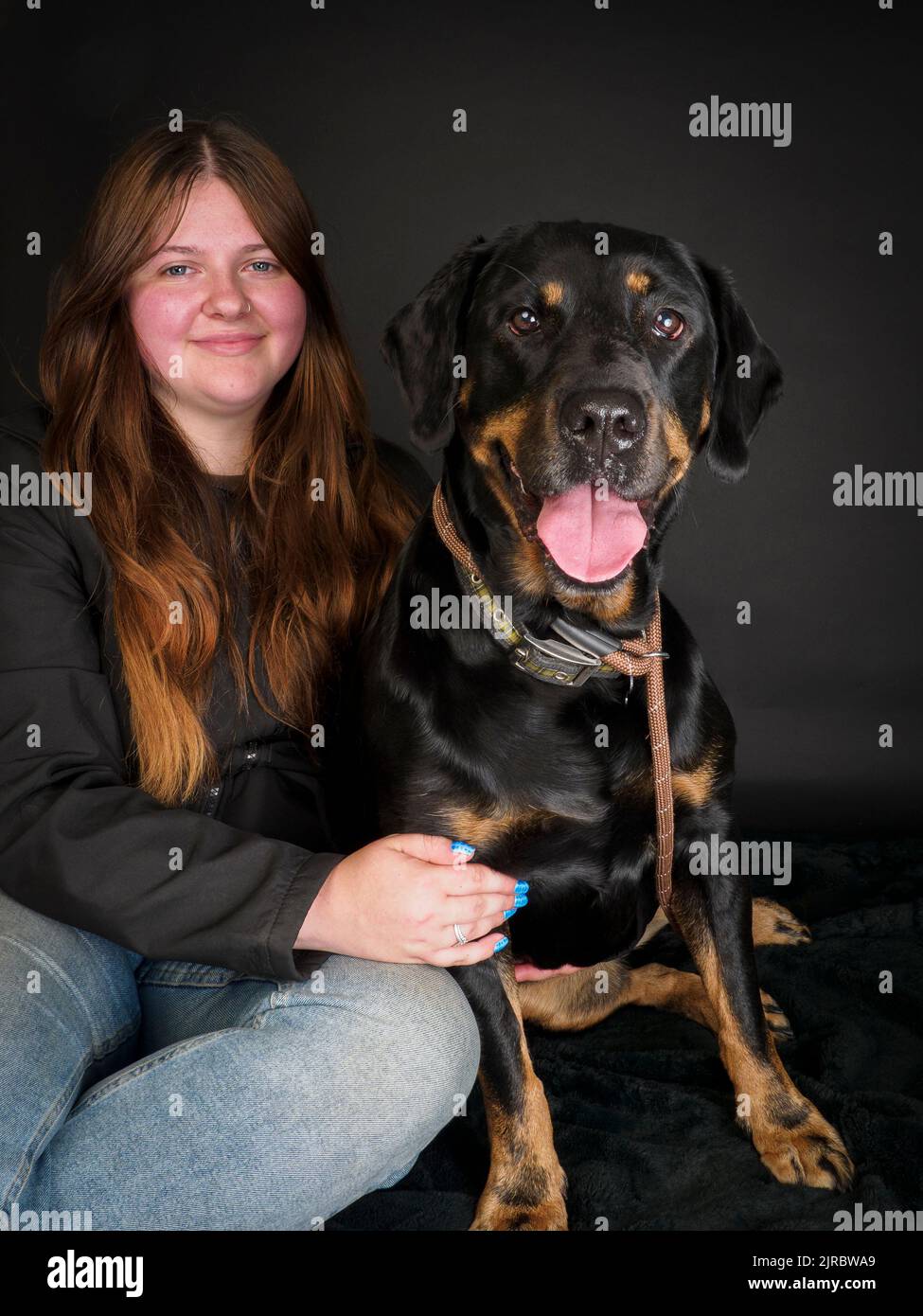 Studio portrait of a Rottweiler and owner. Stock Photo