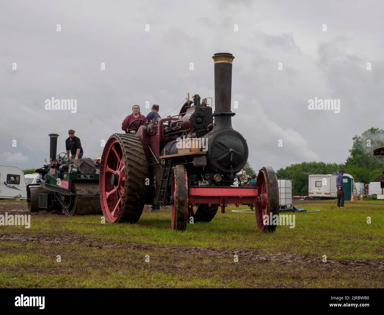 Traction engine towing a steamroller out of the mud at the Launceston Steam & Vintage Rally, Cornwall, UK Stock Photo