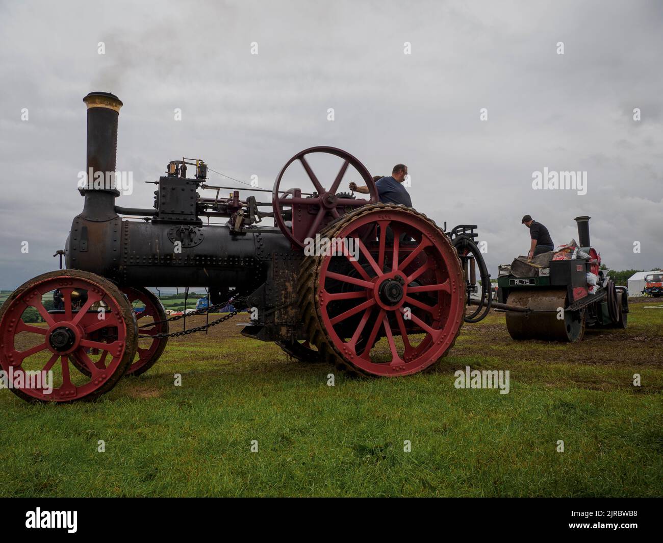 Traction engine towing a steamroller out of the mud at the Launceston Steam & Vintage Rally, Cornwall, UK Stock Photo