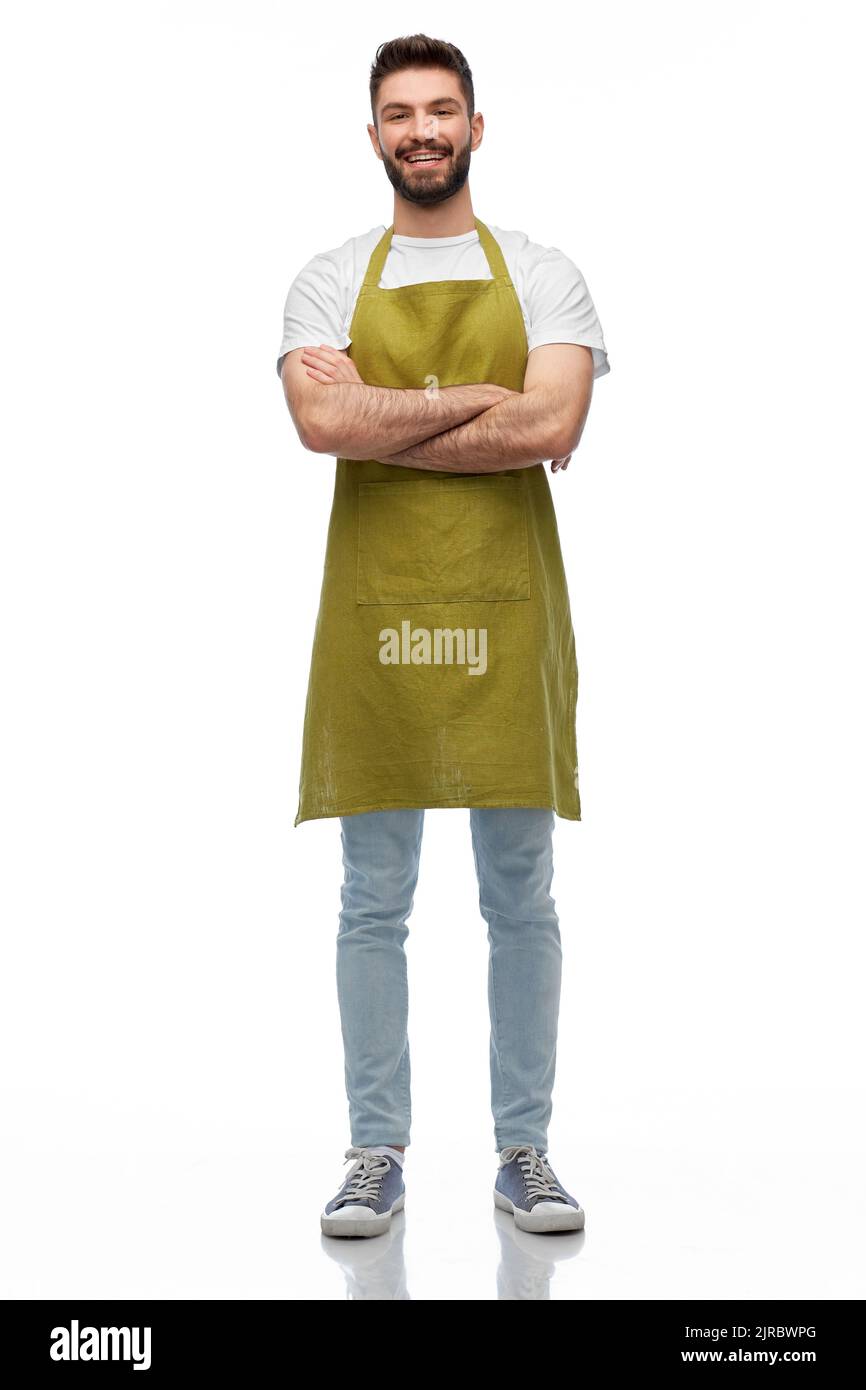 happy barman or waiter in apron with crossed arms Stock Photo