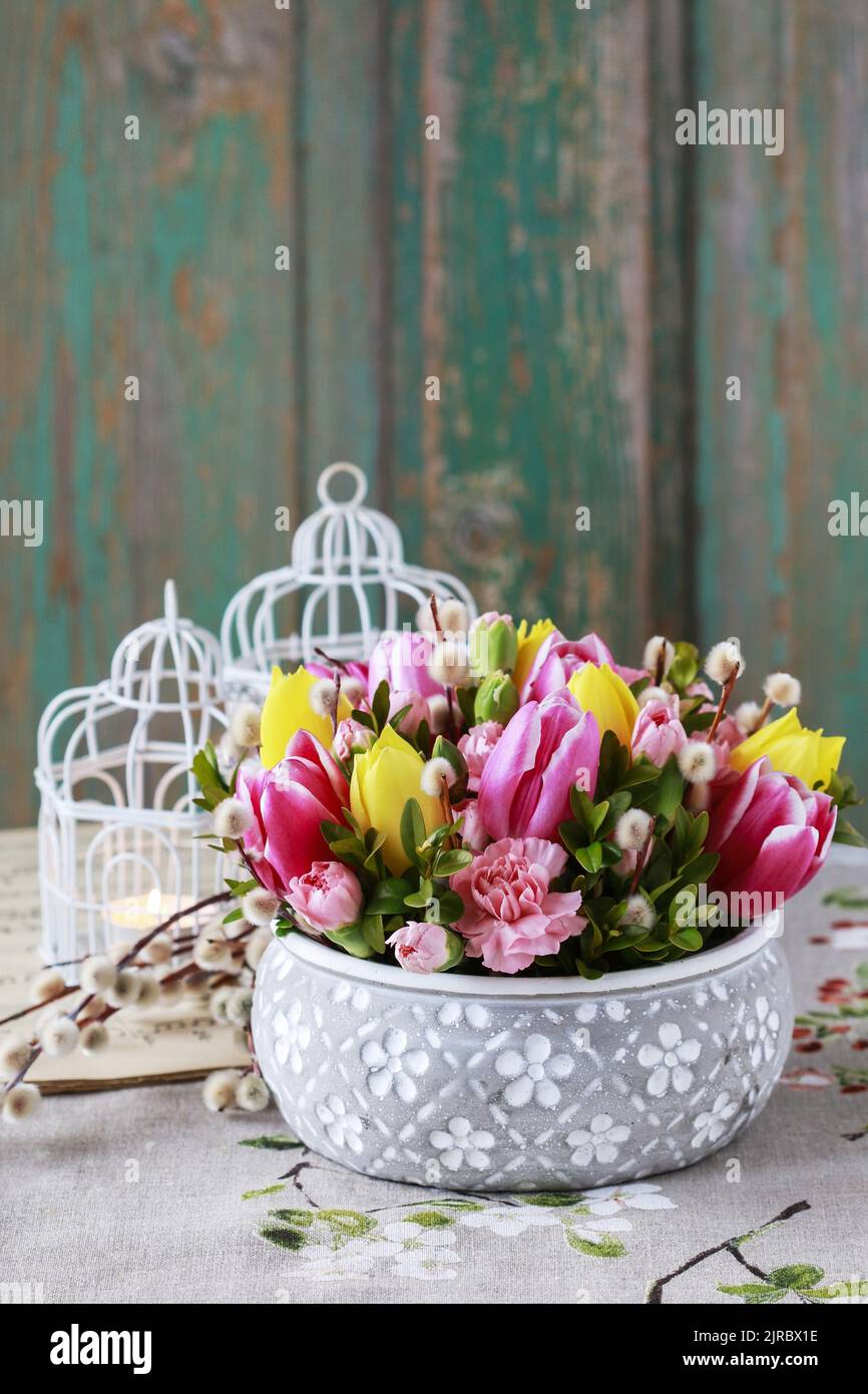 Beautiful floral arrangement with tulip and carnation flowers. Easter home decoration. Stock Photo