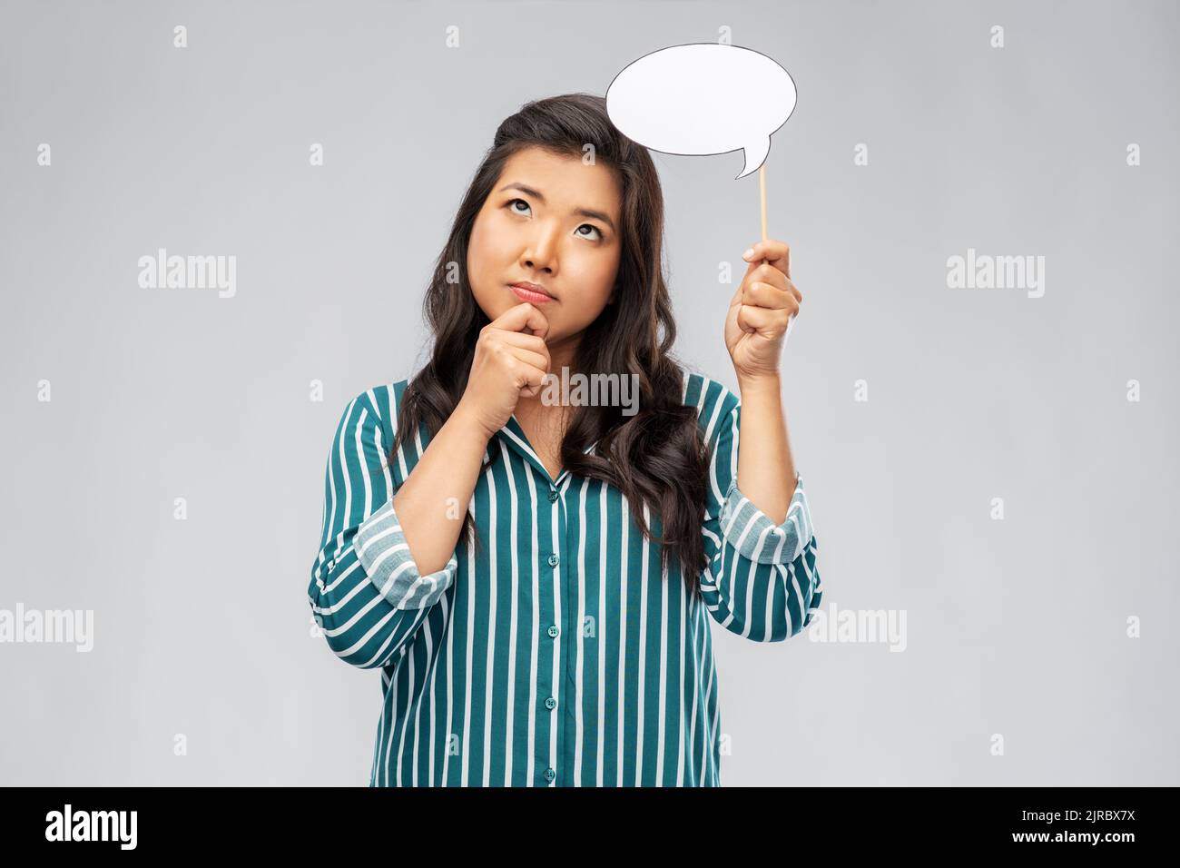 thinking asian woman holding speech bubble Stock Photo