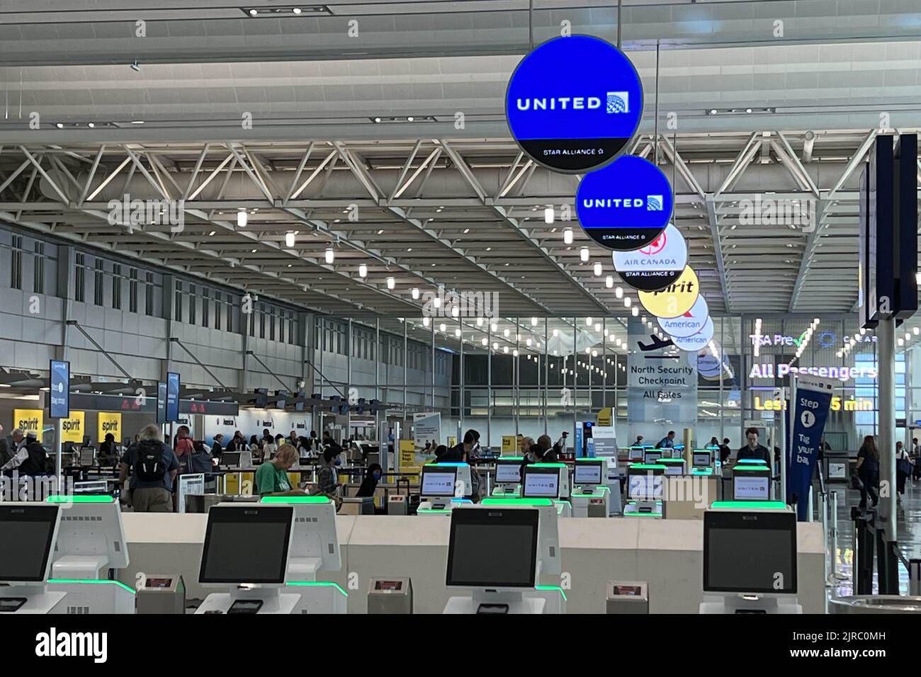 A United Airlines logo and ticketing and check in kiosks are seen 