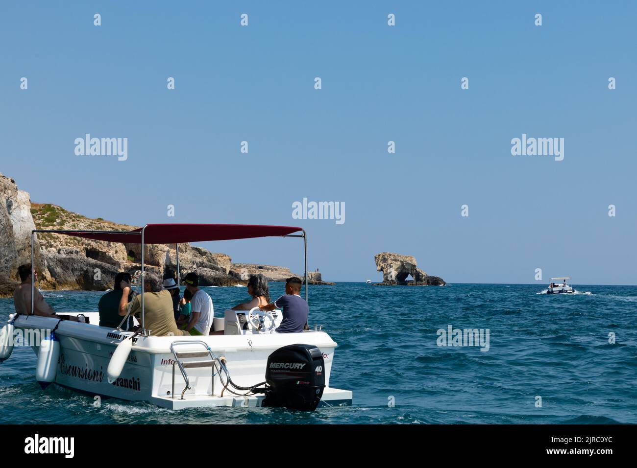 Boats from Siracusa harbour offer trips to the caves and around the island of Ortygia. Stock Photo