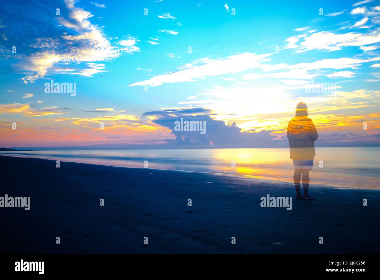 Lone person ghosted  on beach, sunrise,  Hilton Head Island SC. Stock Photo