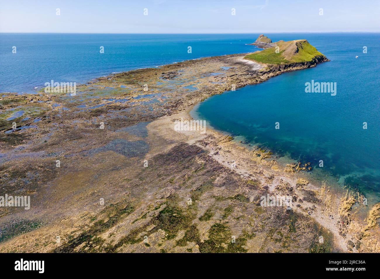 Aerial view of a causeway connecting the mainland to an island at low