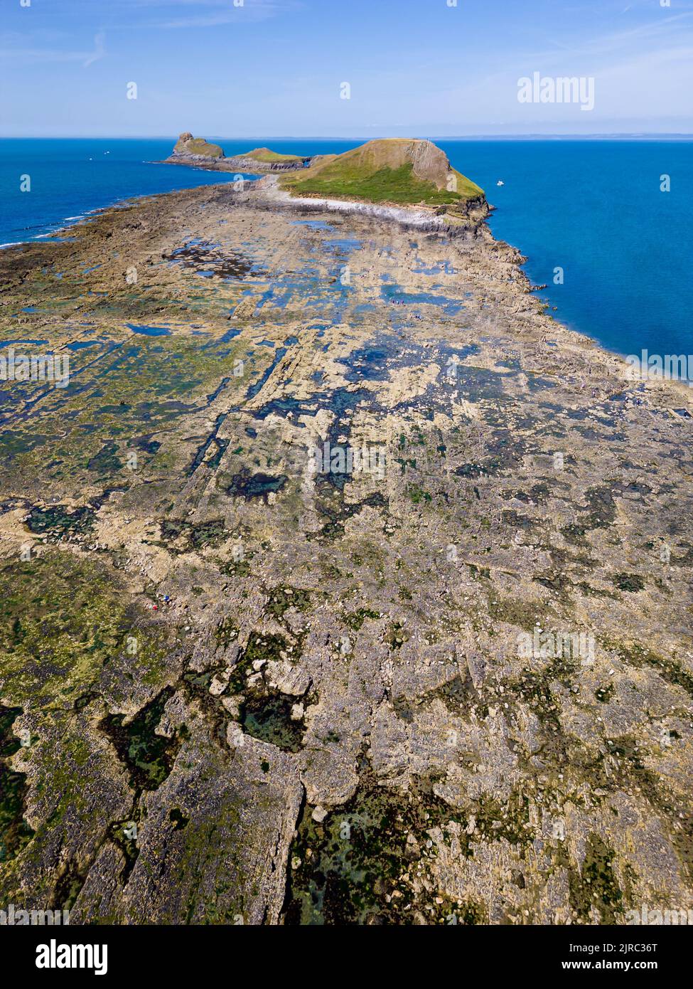 Aerial view of a causeway connecting to an island at low tide (Worms