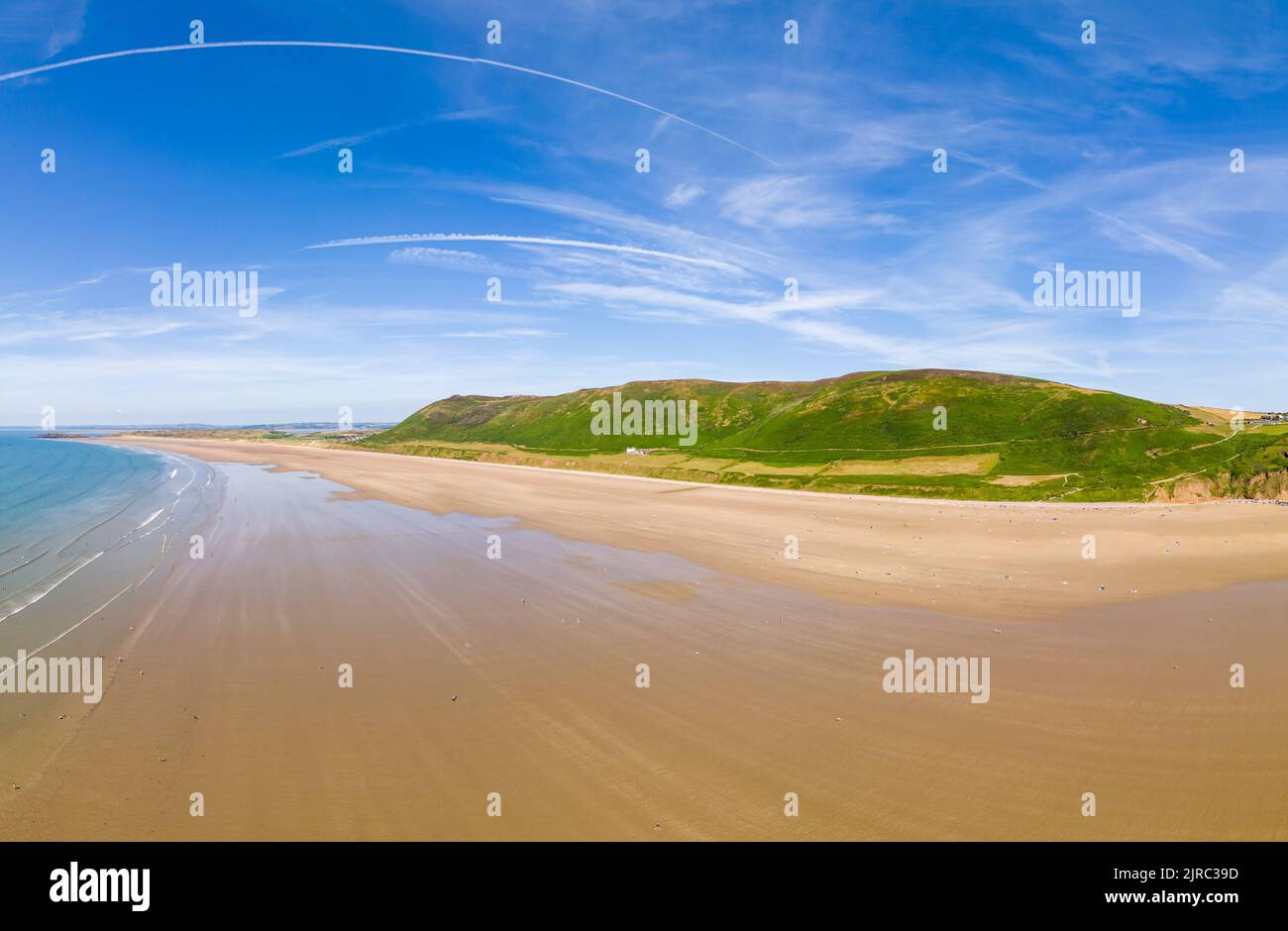 Aerial view of tourists on a huge, wide sandy beach on the coast of Wales (Rhossili, Gower, Wales) Stock Photo
