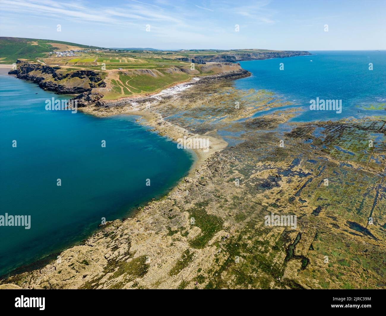 Aerial view of a causeway connecting the mainland to an island at low tide (Worm's Head, Rhossili, Wales) Stock Photo