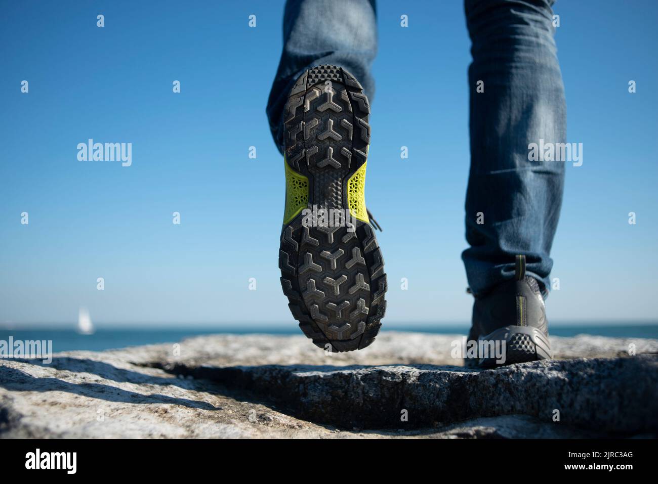 Close up of walking shoes, man walking away. Stock Photo