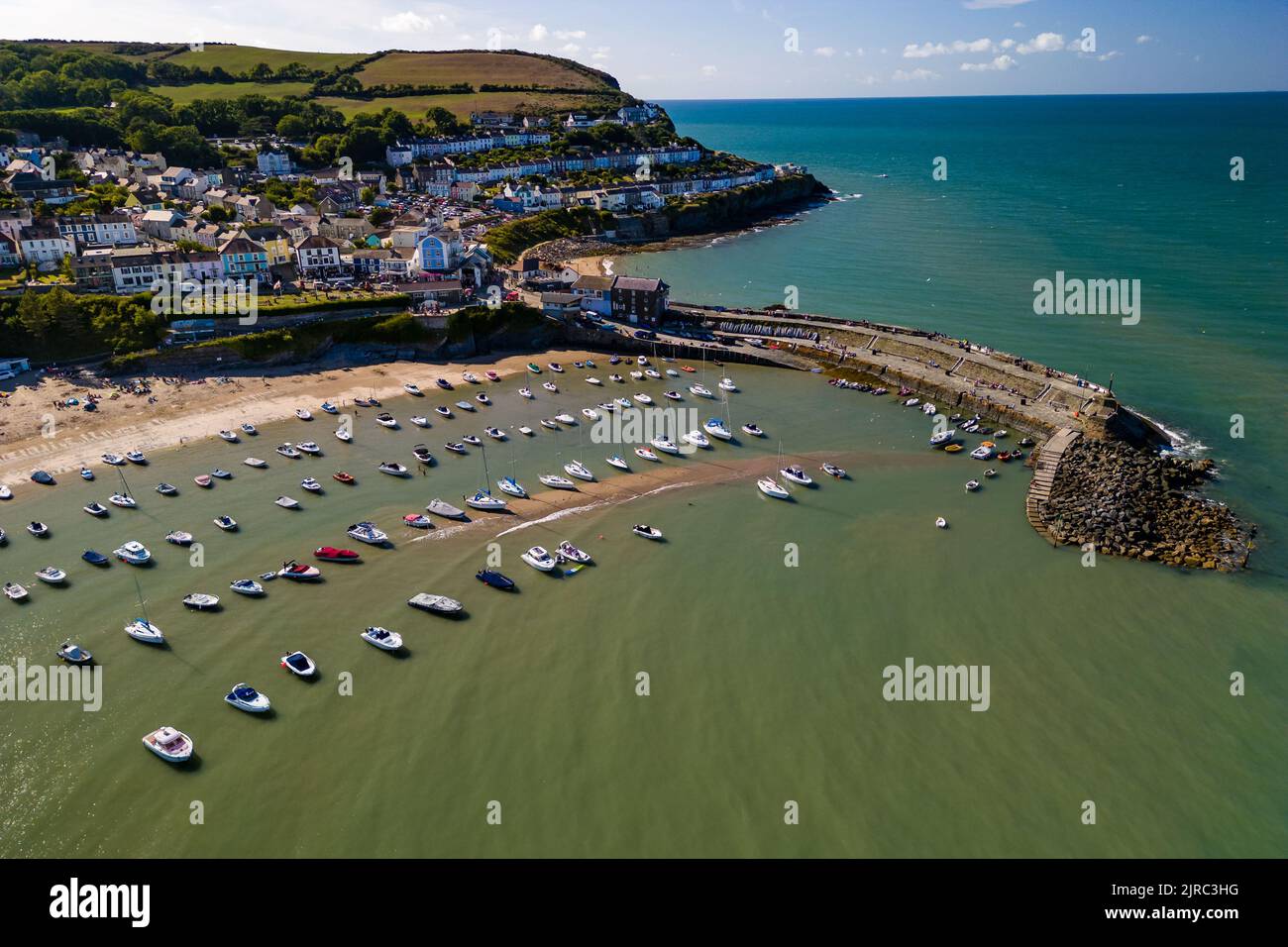 Aerial view of boats and the beach at the colorful Welsh seaside town of New Quay in Cardigan Bay Stock Photo