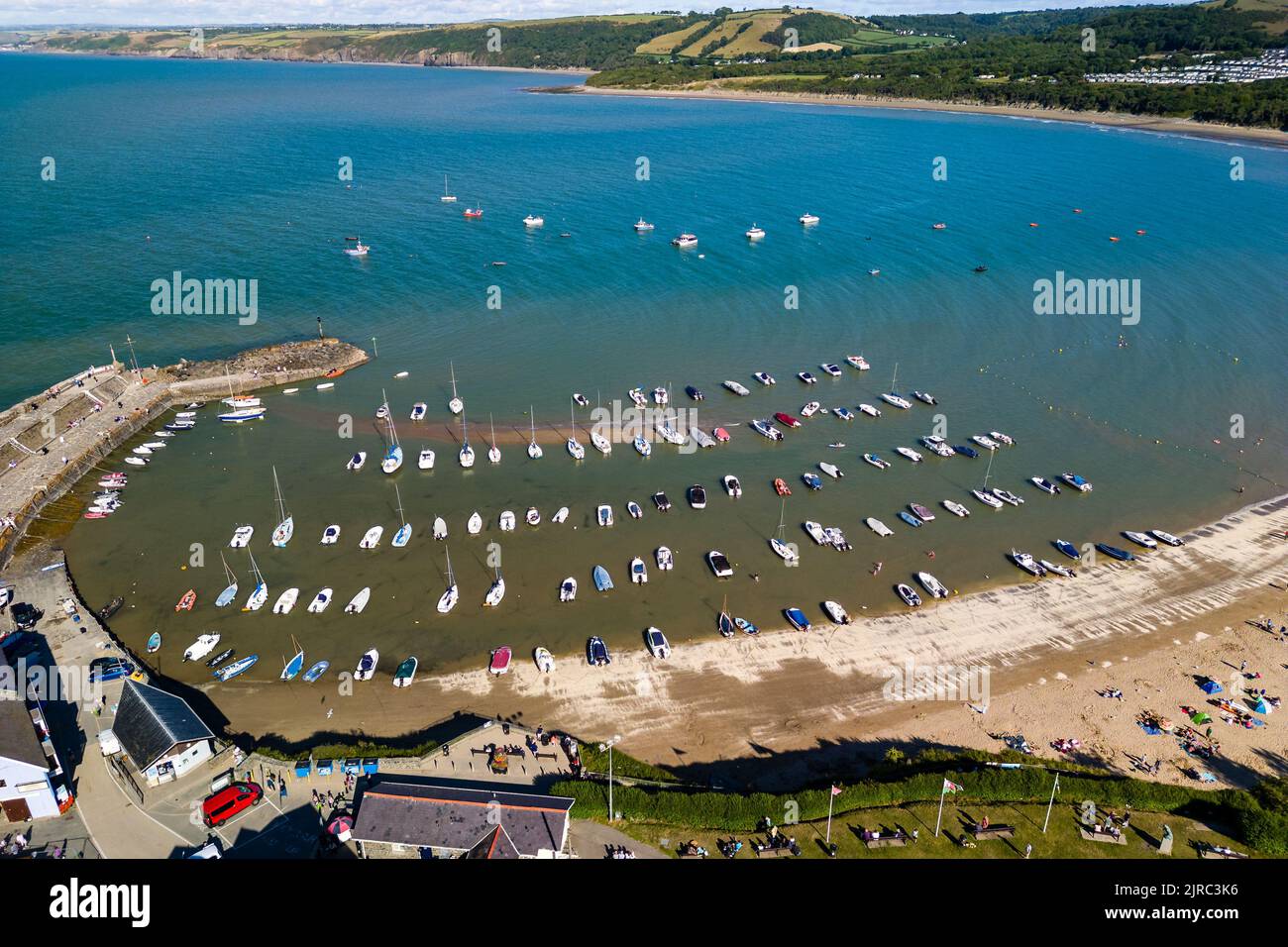 Aerial view of boats in the harbour at low tide in the Welsh seaside resort of New Quay (Ceredigion) Stock Photo