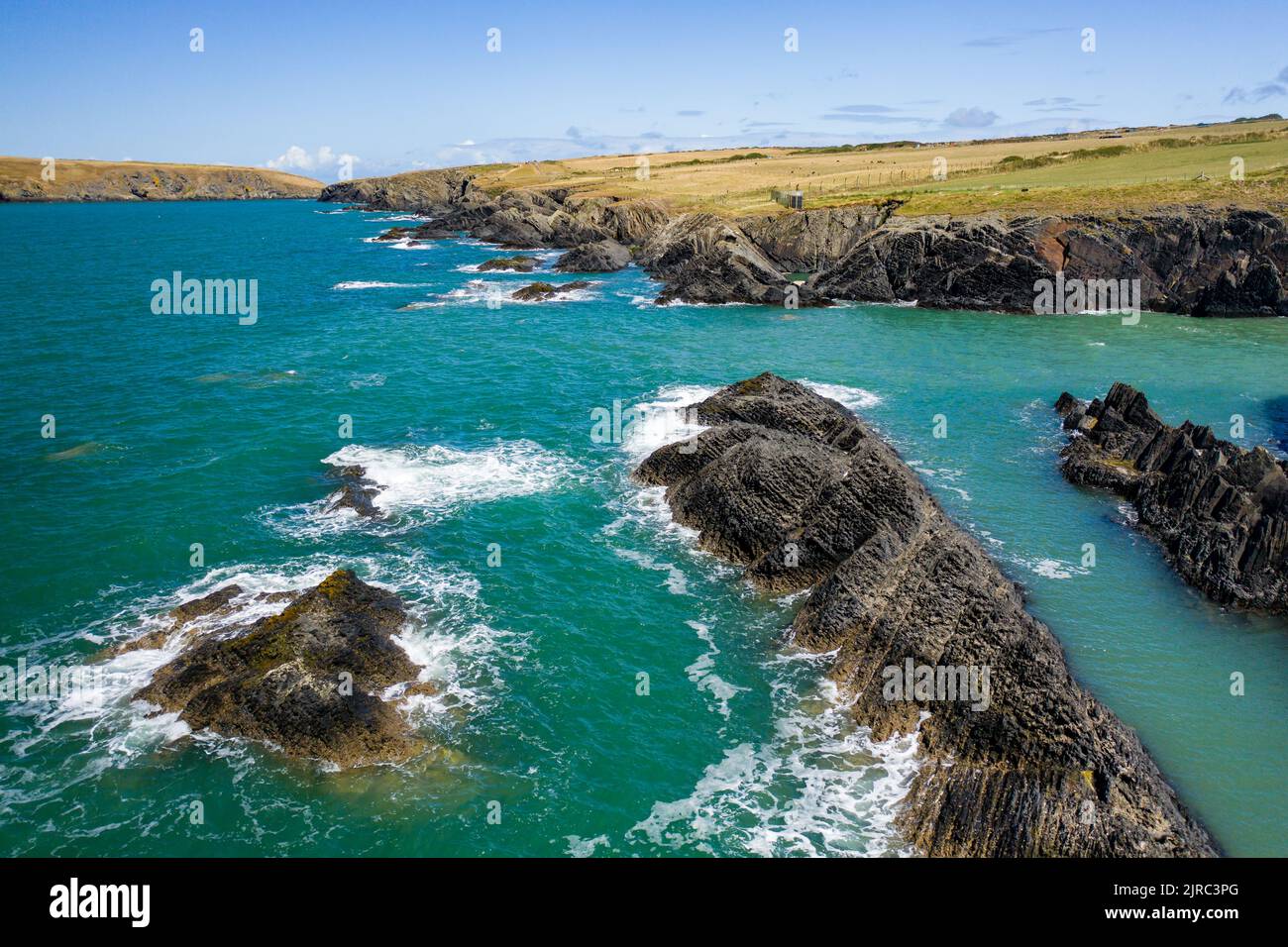 Low altitude aerial view of the rugged Welsh coastline in Pembrokeshire (Gwbert, Wales) Stock Photo