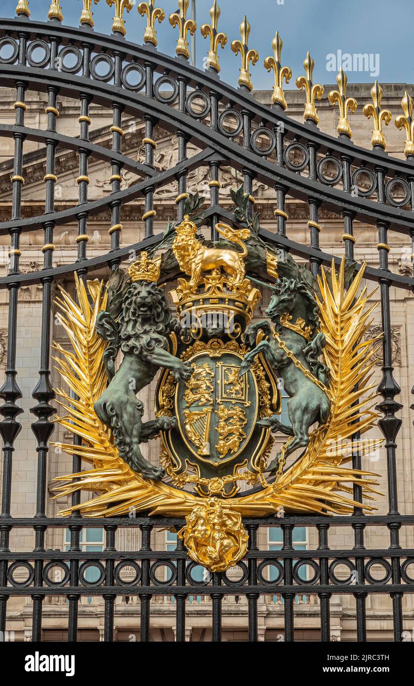 London, England, UK - July 6, 2022: Buckingham Palace. Closeup of golden royal coat of arms fixed to black metal main gate. Stock Photo