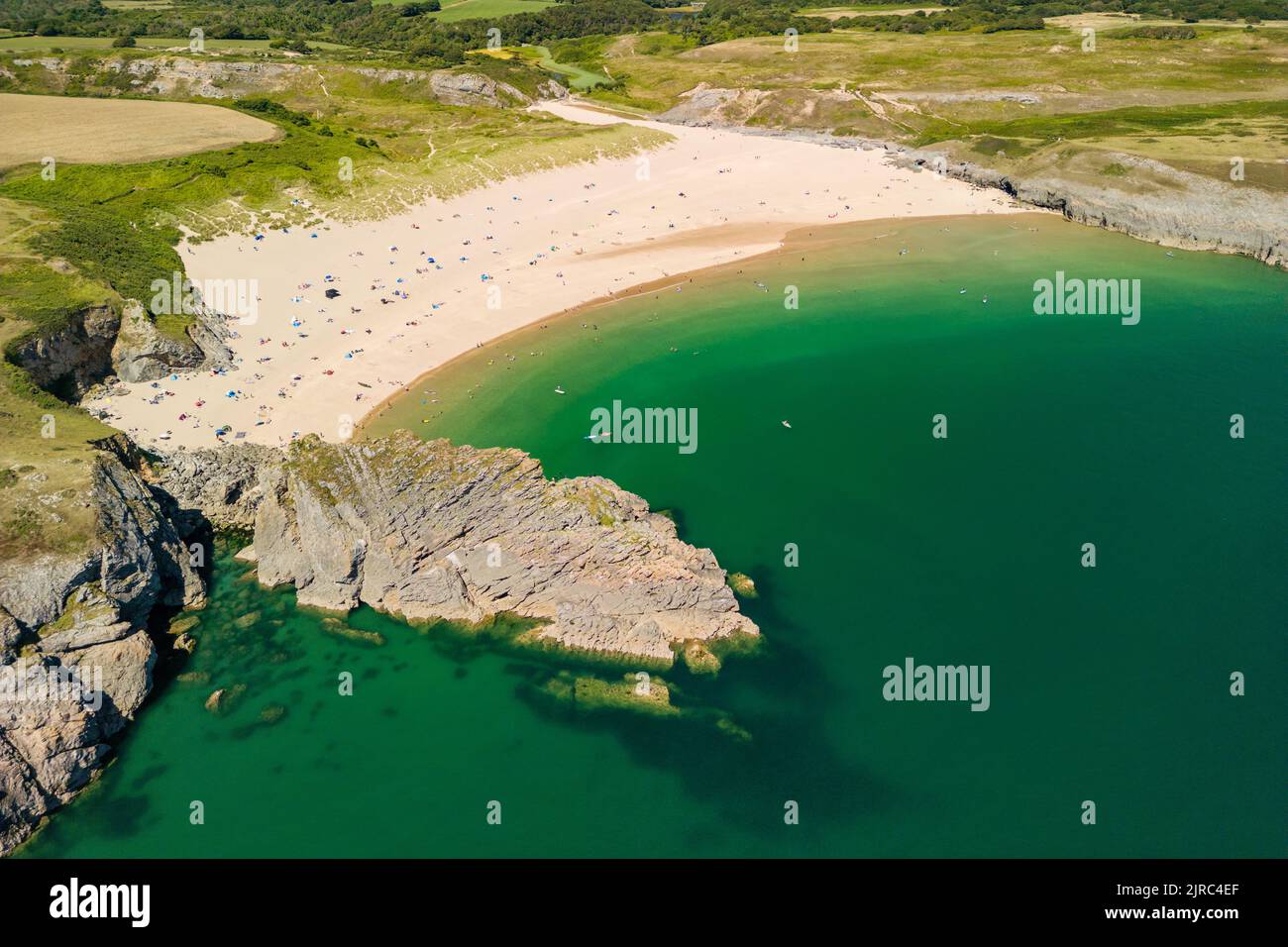 Aerial view of a large, busy sandy beach and rocky coastline in West Wales (Broad Haven South, Pembrokeshire, Wales) Stock Photo
