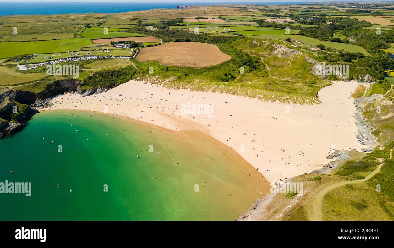 Aerial view of a large, busy sandy beach and rocky coastline in West Wales (Broad Haven South, Pembrokeshire, Wales) Stock Photo
