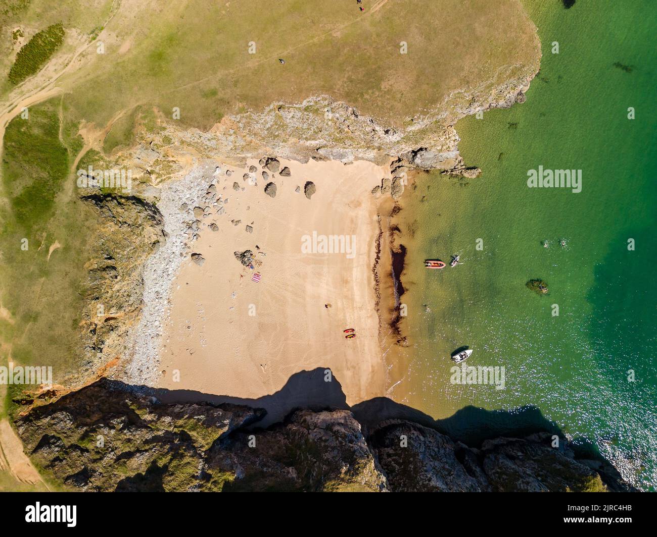 Top down aerial view of a tiny sandy beach and cove in West Wales (Pembrokeshire) Stock Photo
