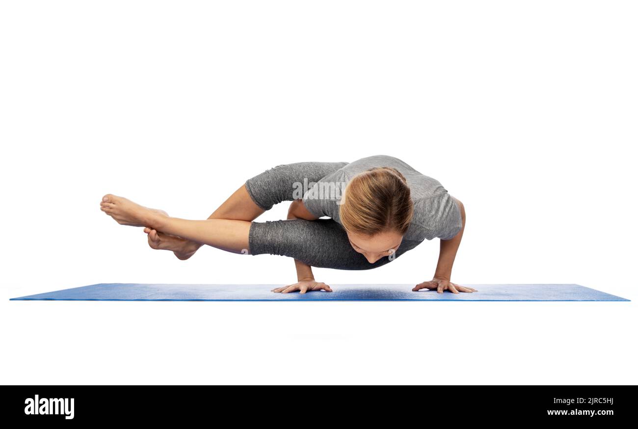 woman making yoga in handstand on mat Stock Photo