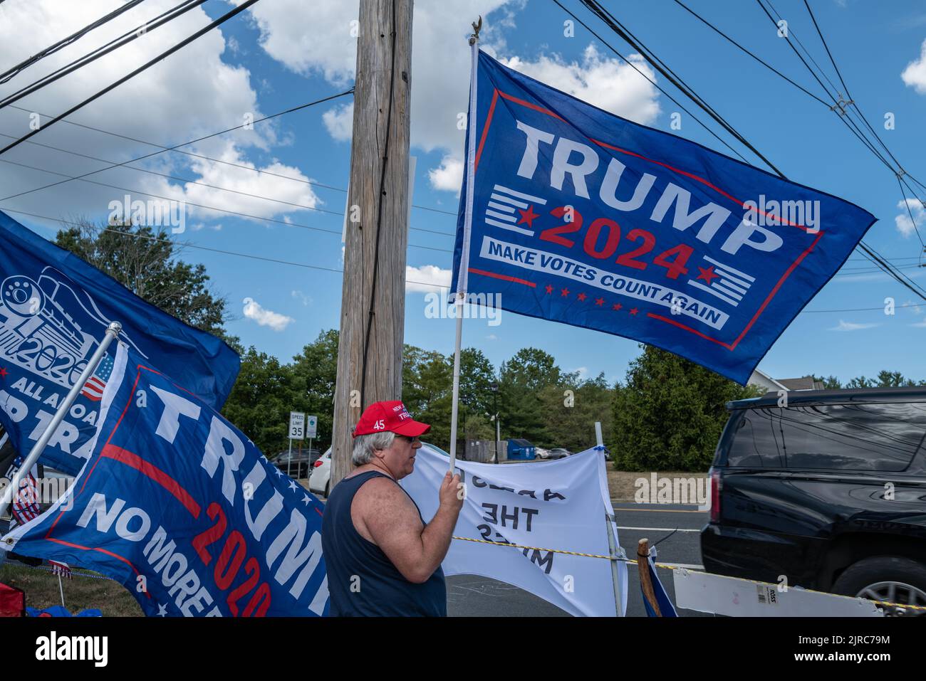 BEDMINSTER, N.J. – August 14, 2022: A demonstrator is seen during a ‘Stand with Trump’ event near the Trump National Golf Club Bedminster. Stock Photo