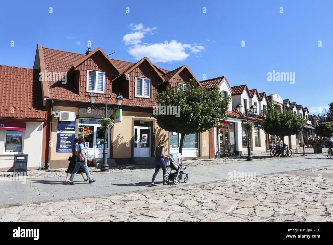 A people walking through an old town of Niepolomice, Poland. Stock Photo