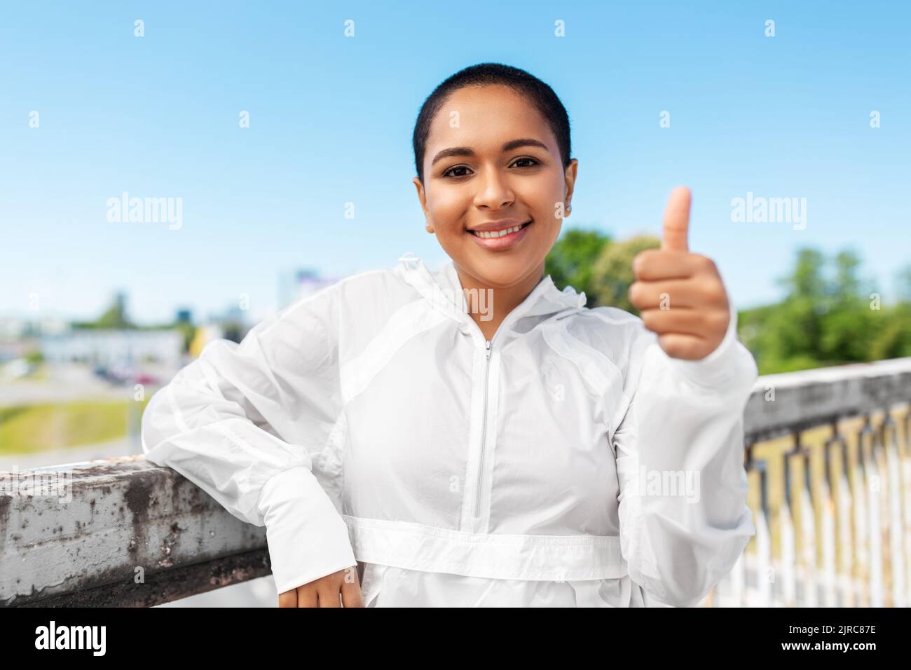 sporty african american woman showing thumbs up Stock Photo - Alamy