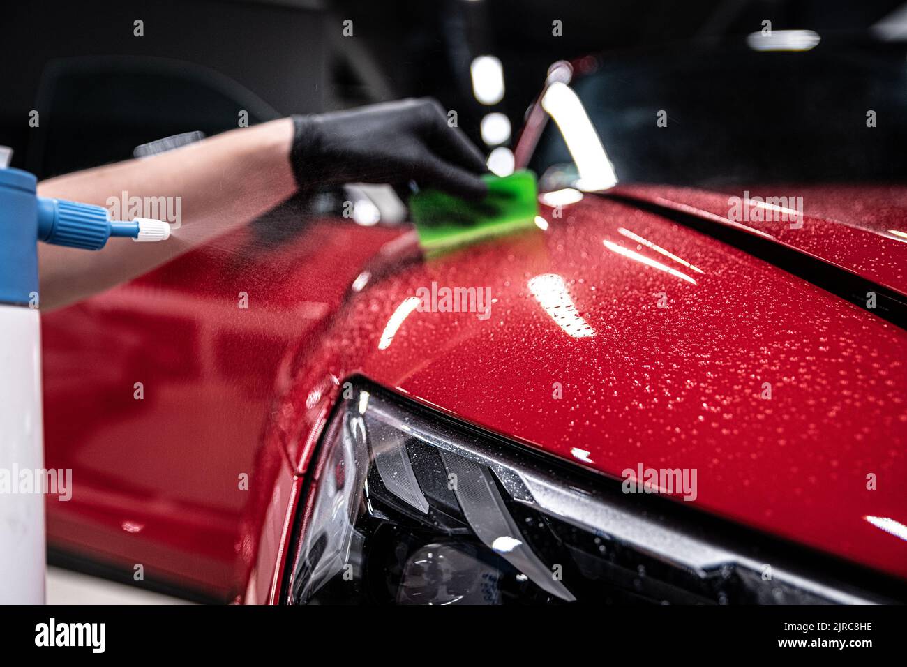 Car Color Less Man car detailing studio employee applies a colorless protective film ...