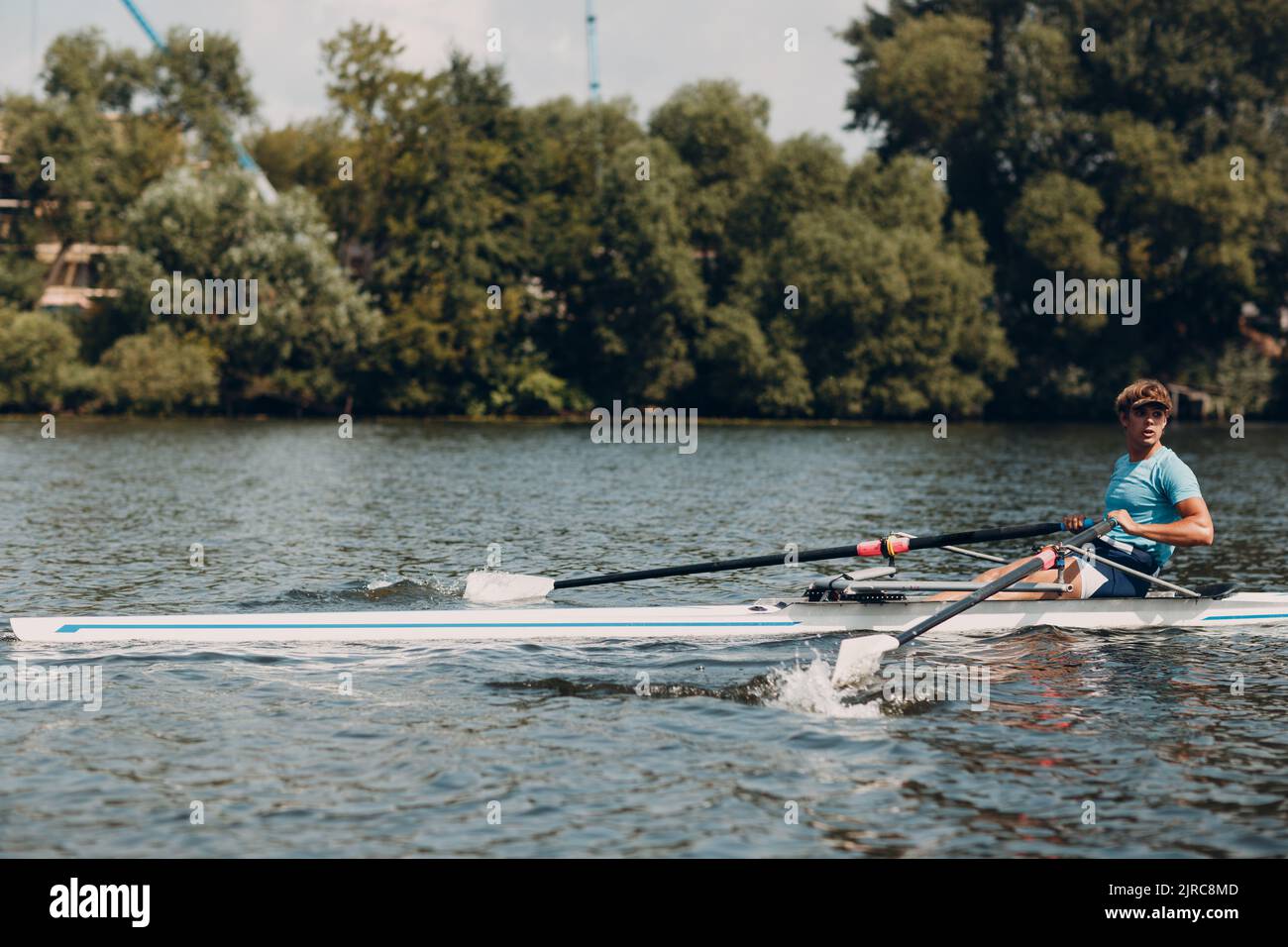 Sportsman single scull man rower rowing on boat. Paddle splash movement ...