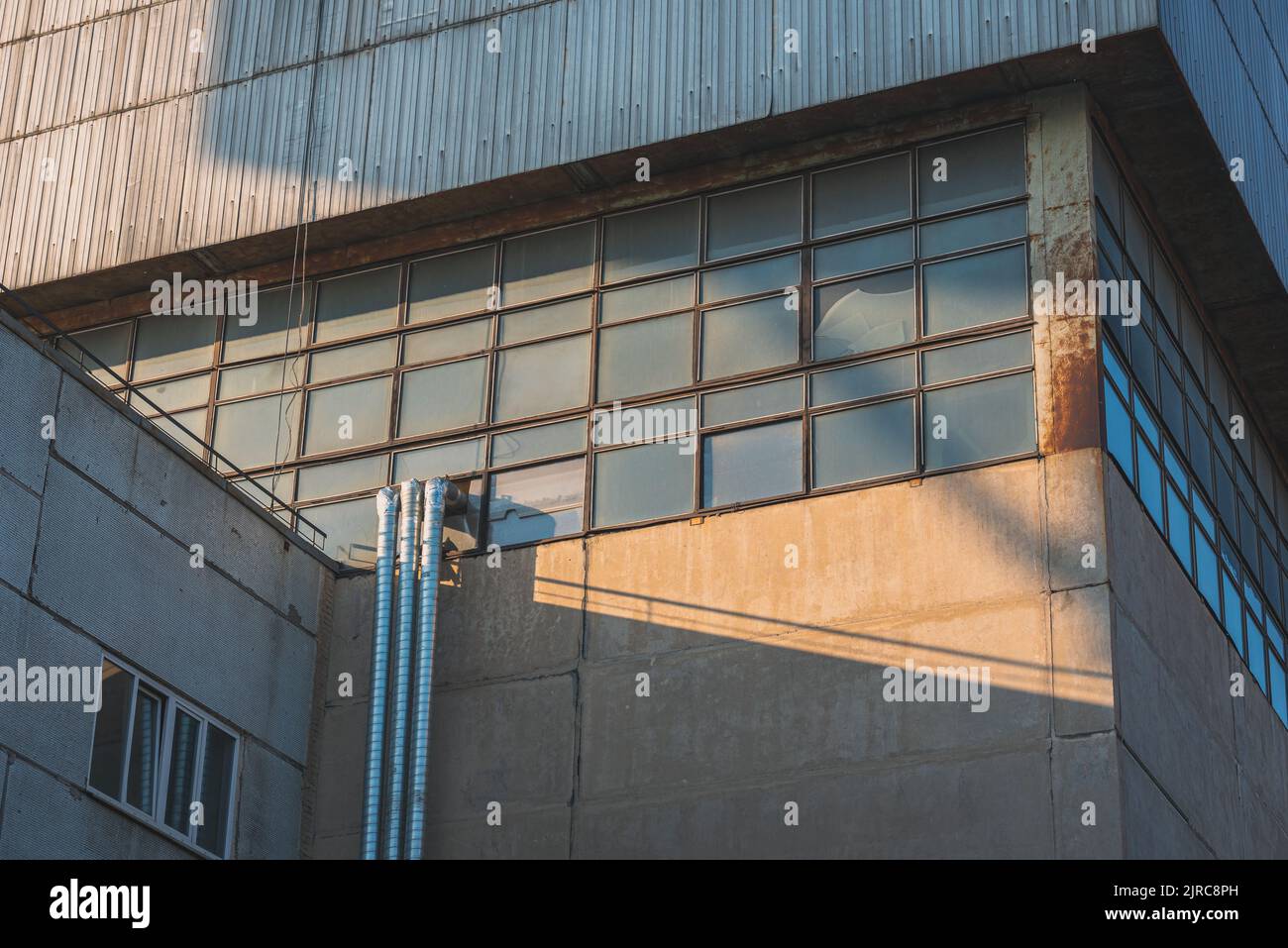 Beautiful sunlight on the windows of a factory building. Stock Photo