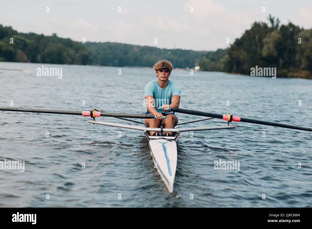 Sportsman single scull man rower rowing on boat Stock Photo - Alamy