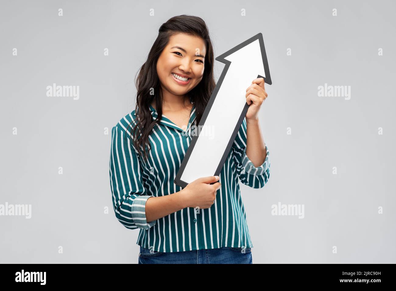 happy smiling asian woman with arrow pointing up Stock Photo - Alamy